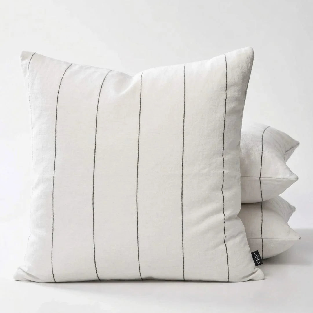 White pillow with black stripes on a white background