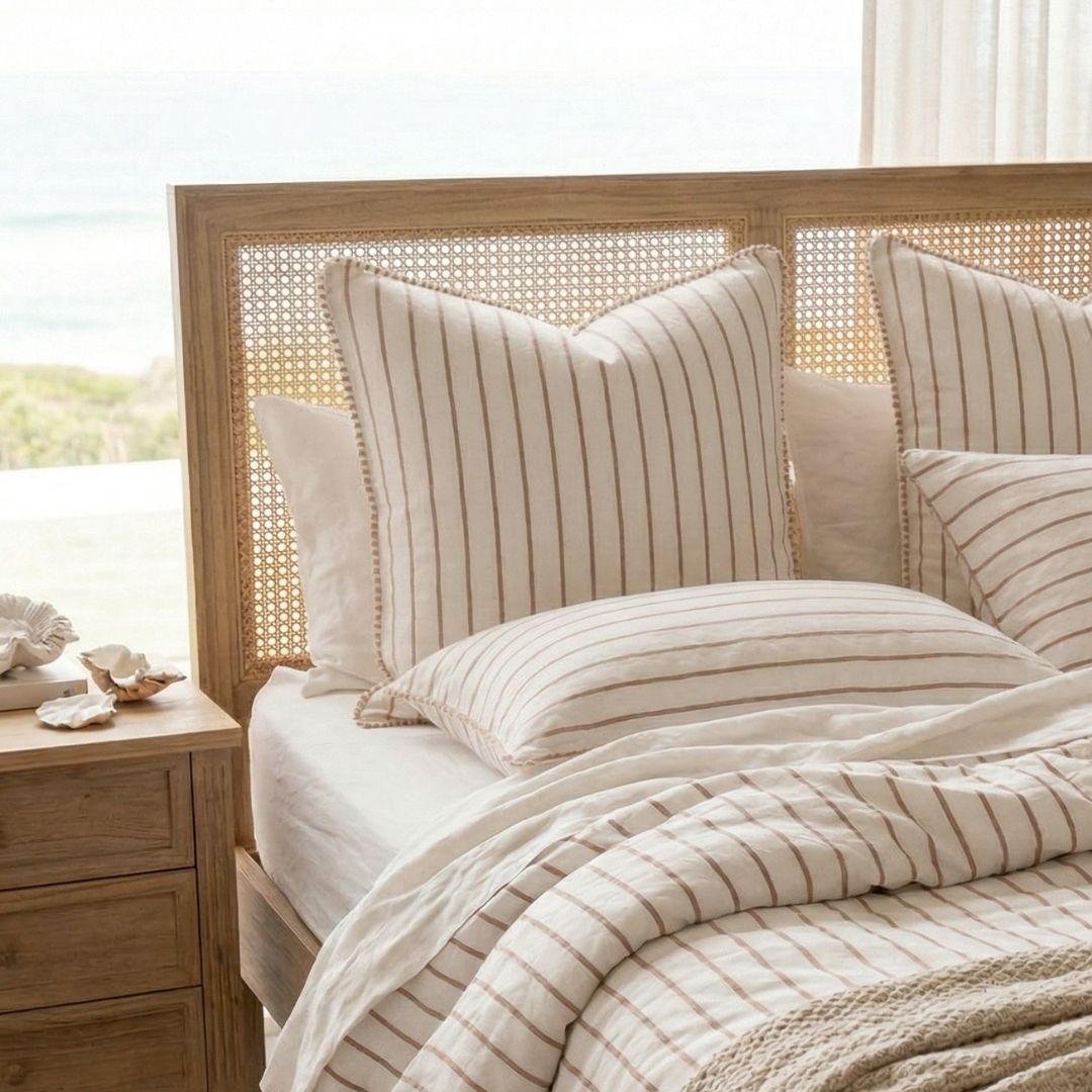 Bed with striped bedding and pillows in a bedroom setting