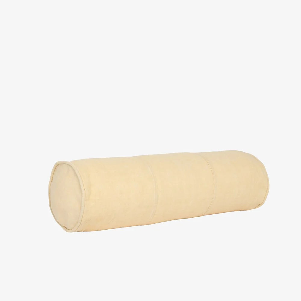 A cylindrical bolster pillow in a light cream or beige fabric, shown horizontally against a plain white background.