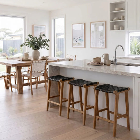 Sun Republic Otis black woven leather and teak counter stools in a modern kitchen