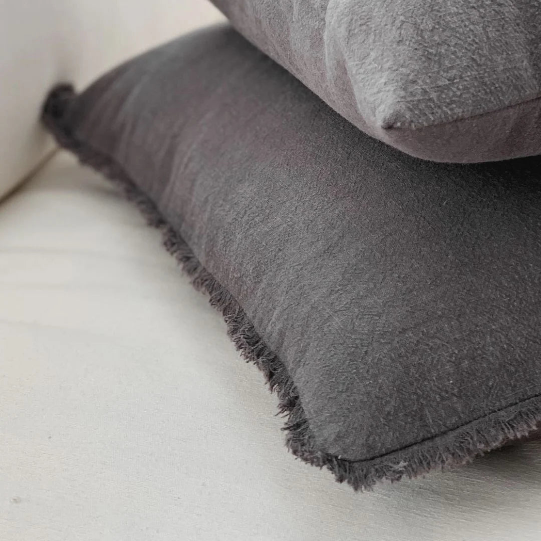Charcoal Gray textured pillows on a light-colored sofa