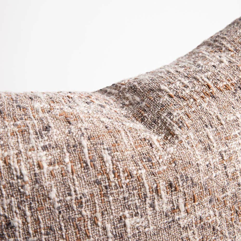 Close-up of textured fabric with a neutral color palette on a white background
