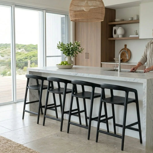 Modern kitchen with marble island and black bar stools