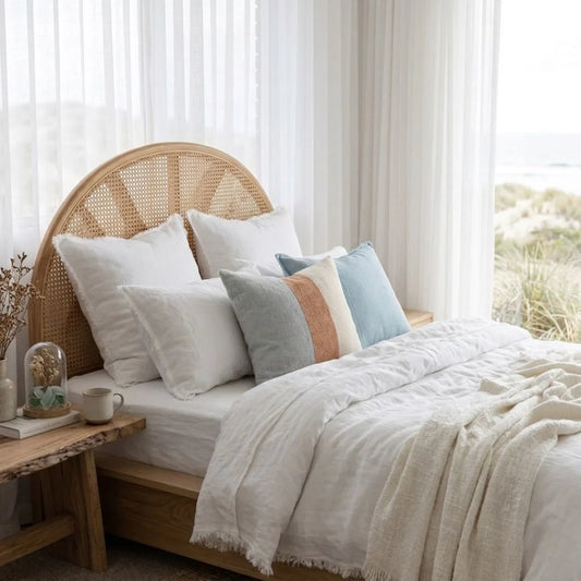 Sun Republic Tallow Cushion and bedding in a styled coastal bedroom