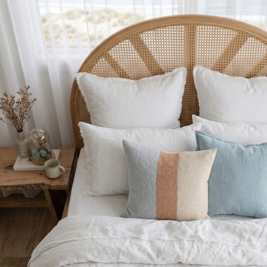 Sun Republic Tallow Cushion and bedding in a styled coastal bedroom