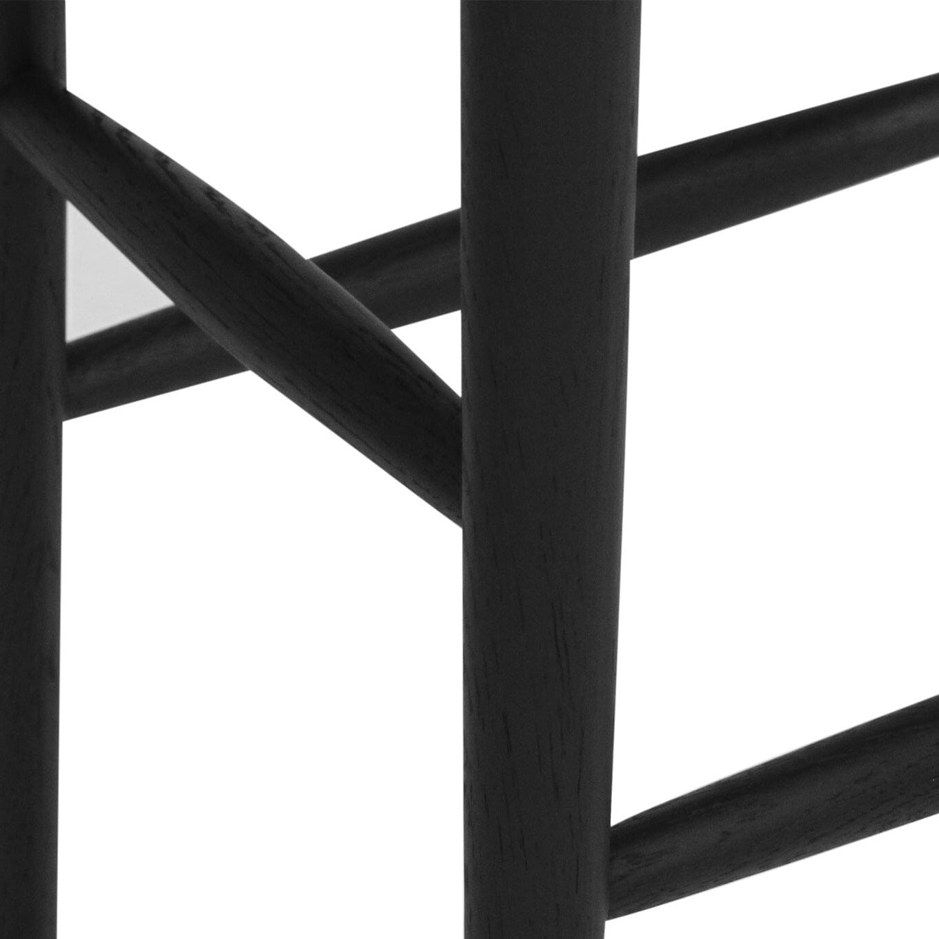 close up of the Jansen American Oak Counter Saddle Stool in black