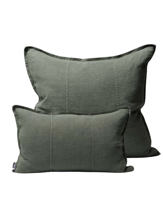 Two green pillows on a white background