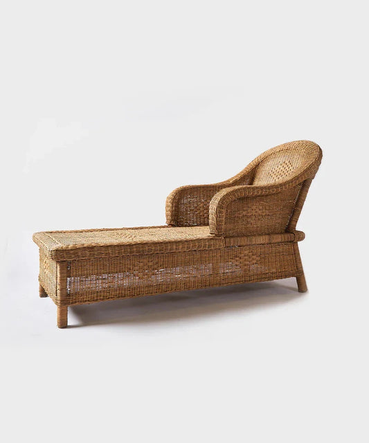 Woven cane sunlounge chair on a white background