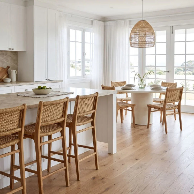 Modern kitchen with white island and wooden chairs