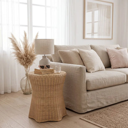 Rattan side table styled as a bedside table in a modern coastal boho living room