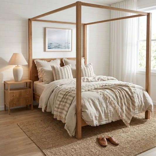 Bedroom with wooden canopy bed, nightstand, and lamp.