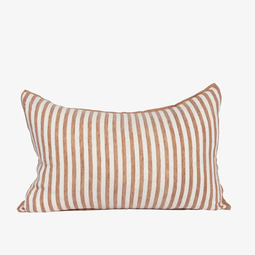 A rectangular throw pillow with vertical stripes in a warm rust-brown and off-white, shown against a plain light gray background.