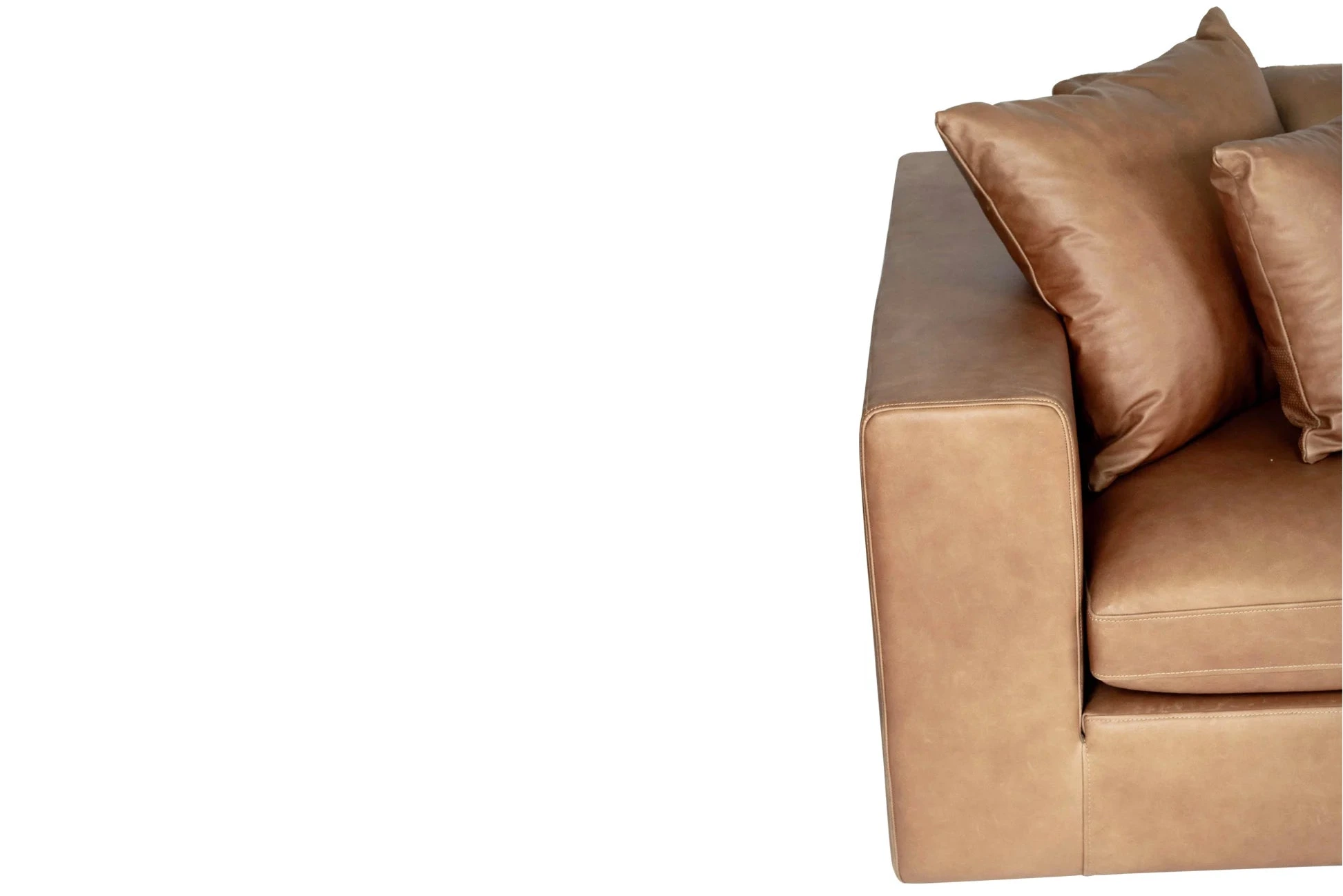 Brown leather sofa with two cushions on a white background