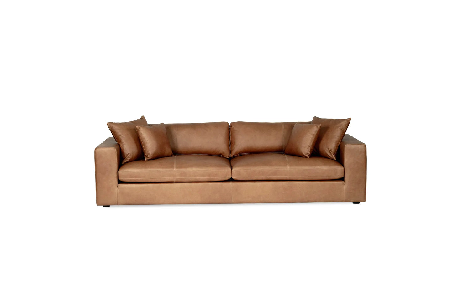 Tan brown saddle leather sofa with cushions on a white background from Sun Republic
