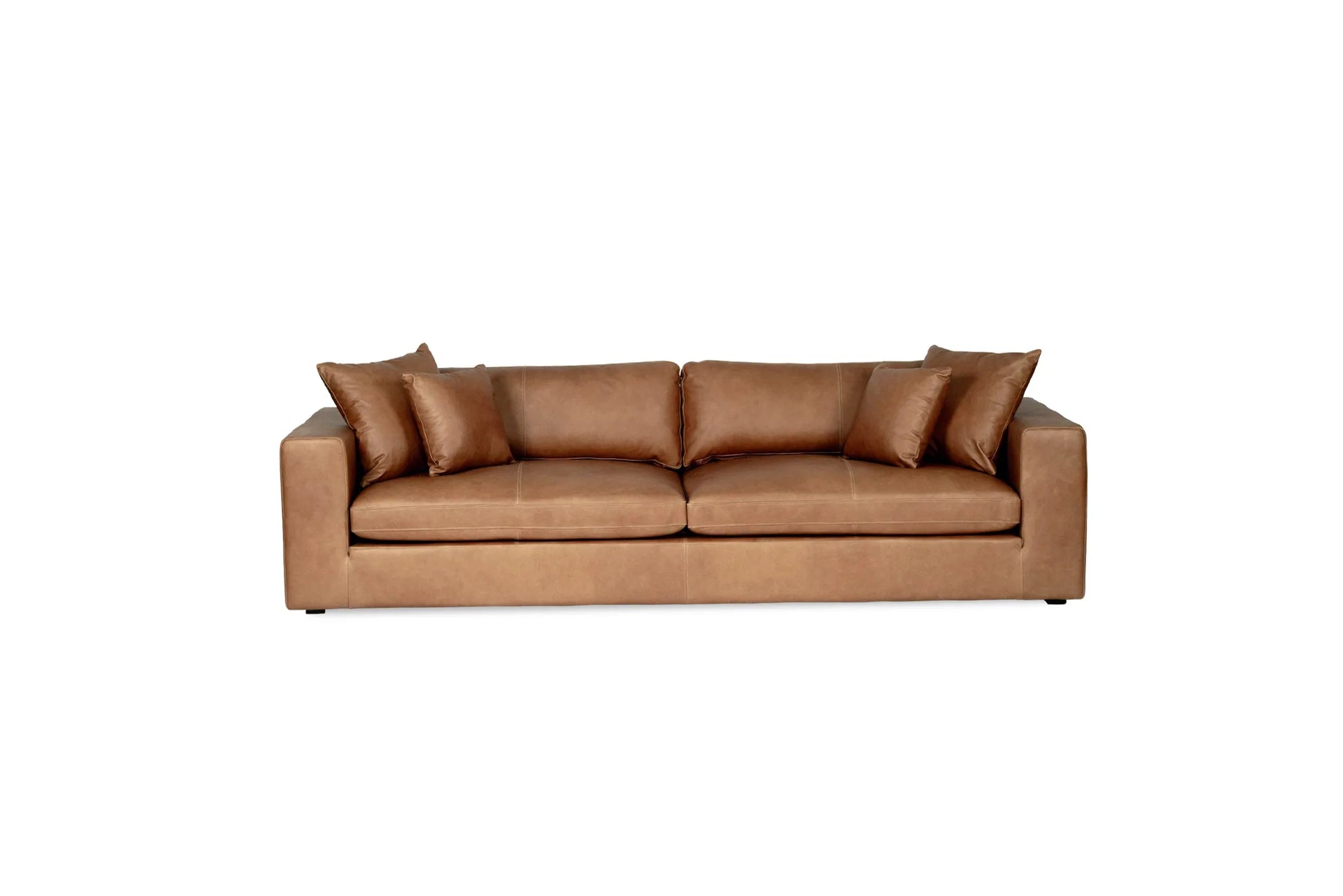 Tan brown saddle leather sofa with cushions on a white background from Sun Republic