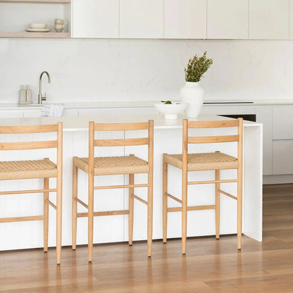 Modern kitchen with white cabinets, a white island, and wooden stools.