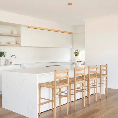 Modern kitchen with white island and wooden stools