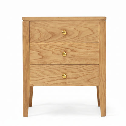 A three-drawer wooden nightstand with a light oak finish and small round brass knobs, shown against a plain white background.
