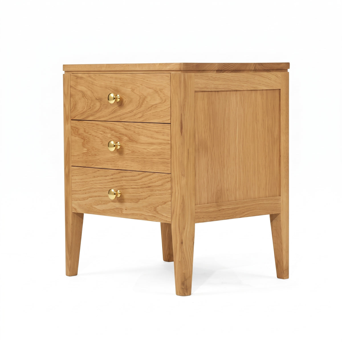 A light oak wood nightstand with three drawers, each featuring a round brass pull handle, and four tapered legs, shown on a white background.