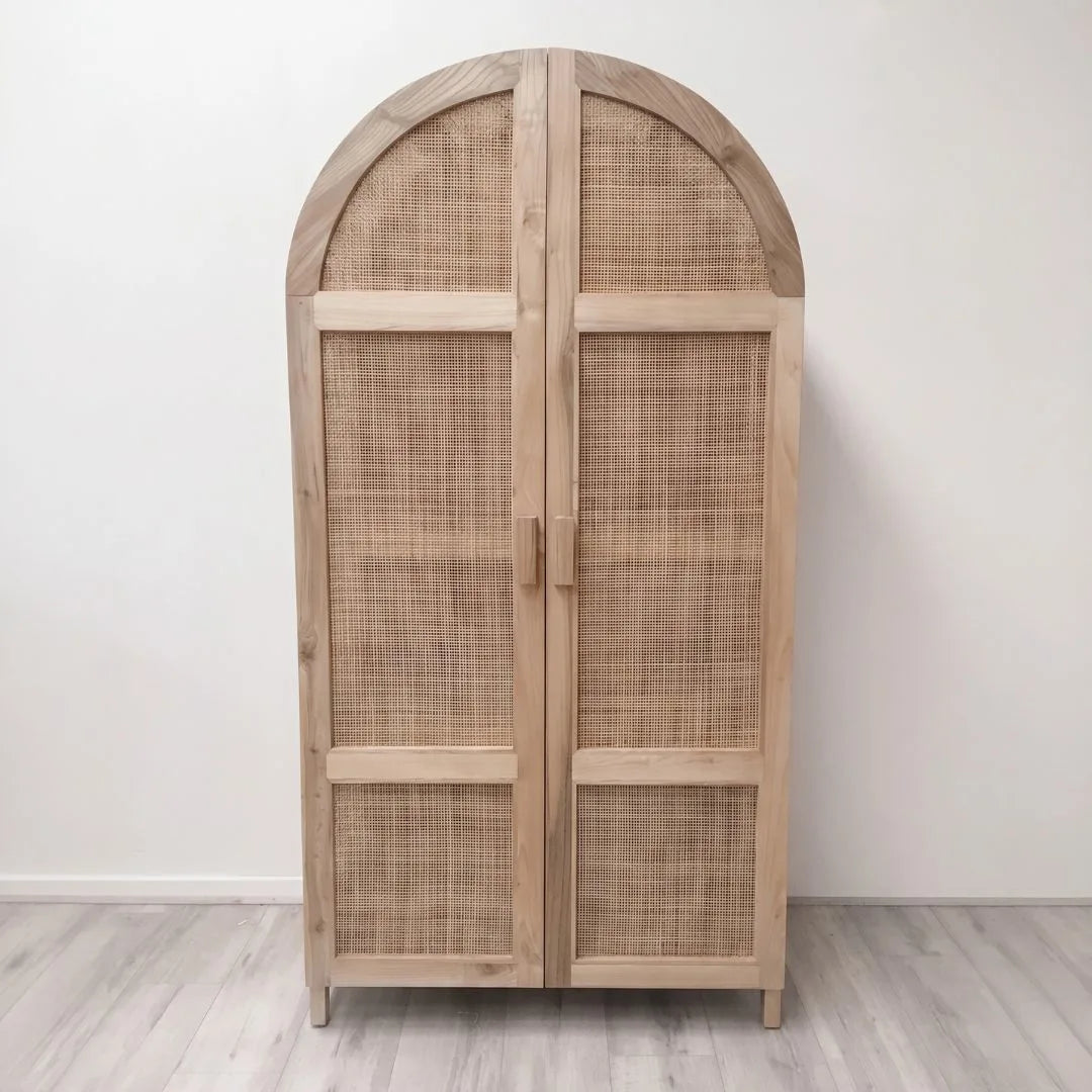 Wooden armoire with wicker doors on a white background