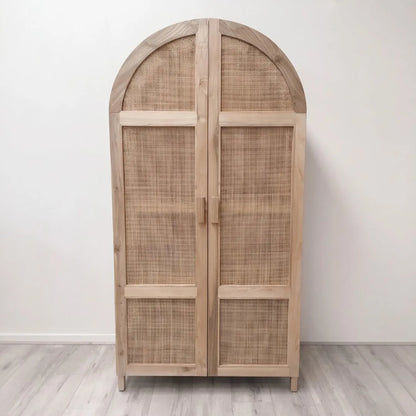 Wooden armoire with wicker doors on a white background
