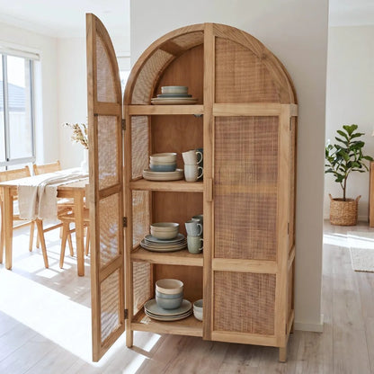 Wooden cabinet with wicker doors in a bright room with a table and chairs.