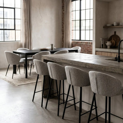Modern kitchen with a long wooden dining table and bar stools.