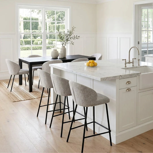 Modern kitchen with white island, bar stools, and a dining table.