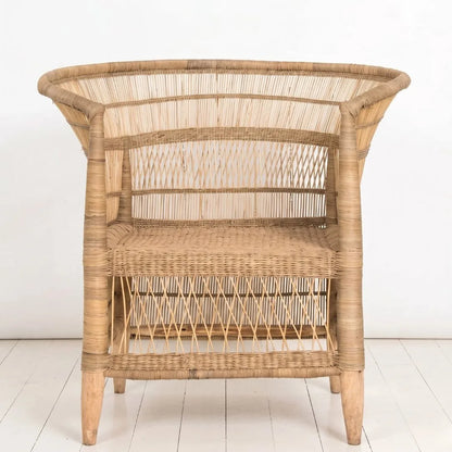 Wicker side table on a white floor with a white wall background