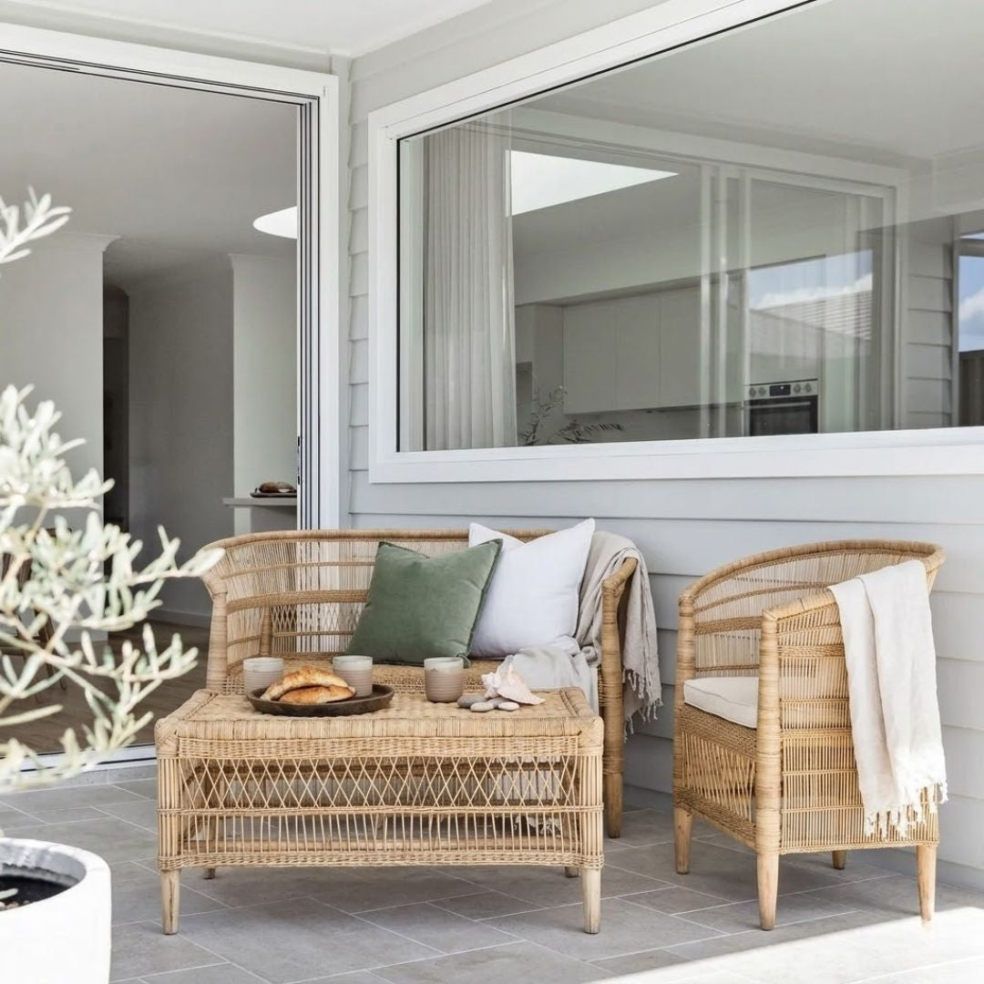 Wicker outdoor furniture set with cushions on a patio