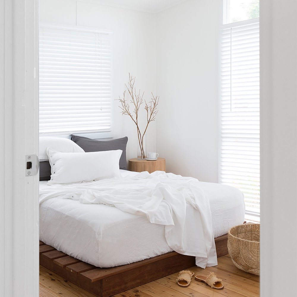 Modern bedroom with a bed, nightstand, and decor elements.