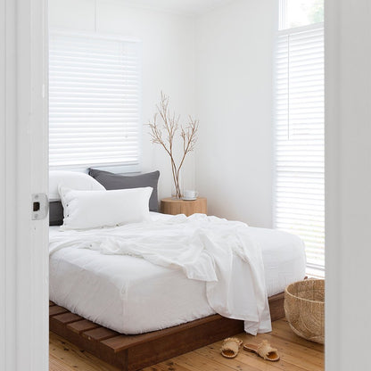 Modern bedroom with a bed, nightstand, and decor elements.
