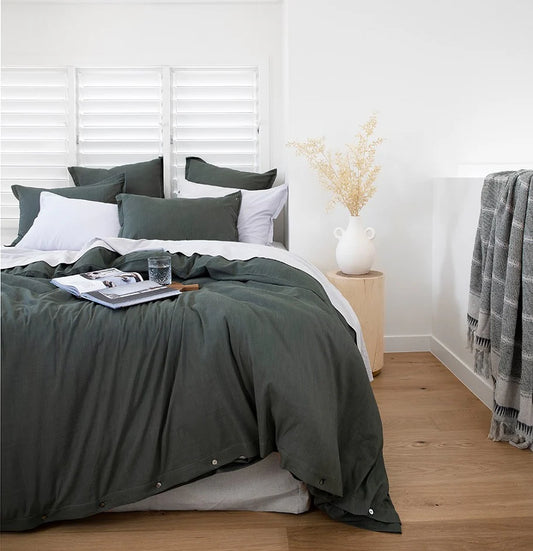 Bedroom with green bedding and white walls
