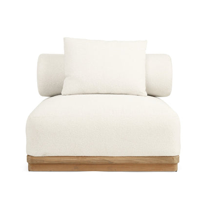 A modern low-profile armchair with a textured off-white bouclé seat and back cushion, featuring cylindrical side bolsters and a natural wood base, shown against a solid white background.