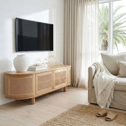 Modern living room with wooden sideboard, TV, and beige sofa.
