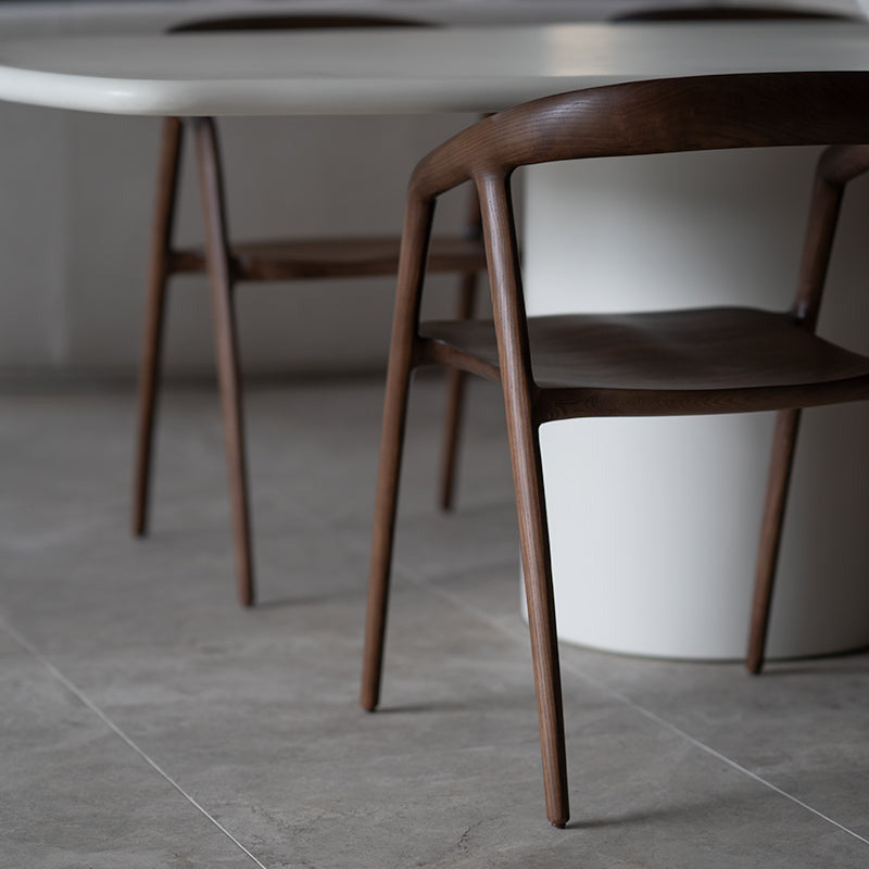Wooden chair in a room with a white table and blurred background