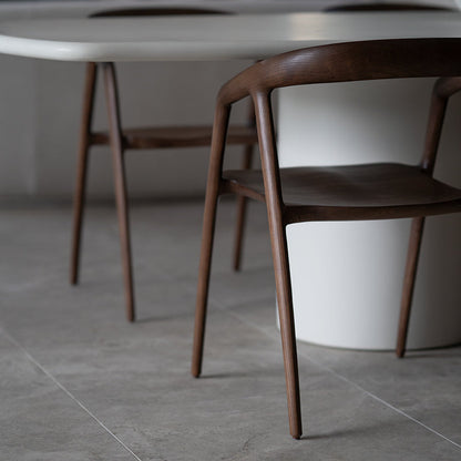 Wooden chair in a room with a white table and blurred background