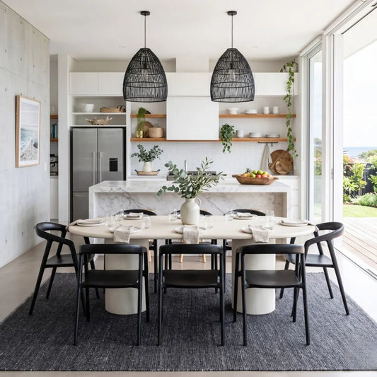 Modern kitchen with dining table and chairs, marble island, and large windows.