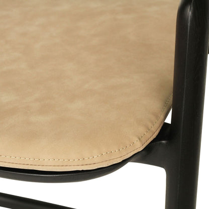 Close-up of a beige chair seat with black metal frame