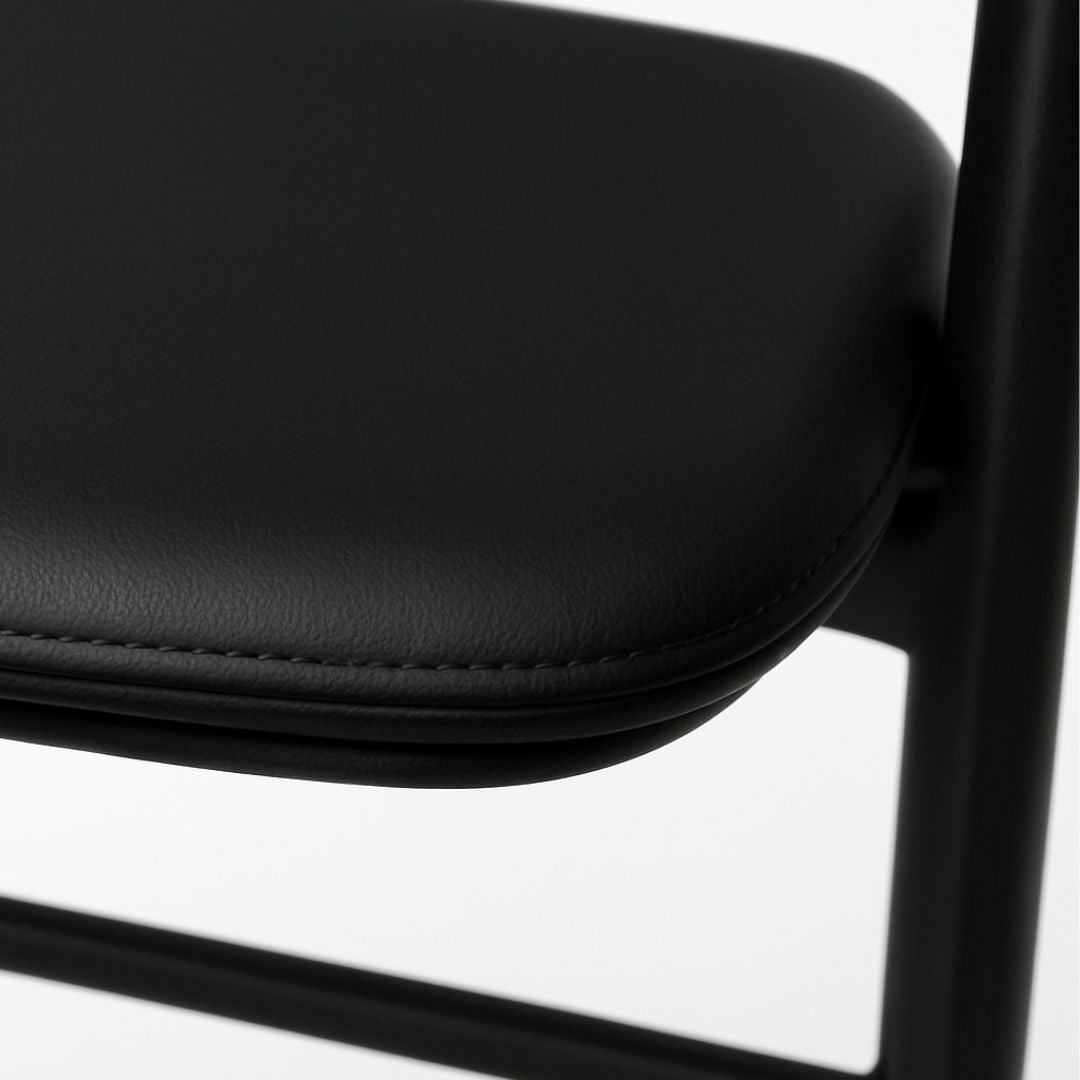 Close-up of a black chair seat on a white background