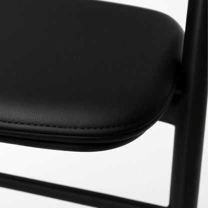 Close-up of a black chair seat on a white background