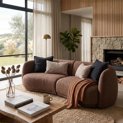 Cozy living room with a brown sofa, coffee table, and decorative elements.