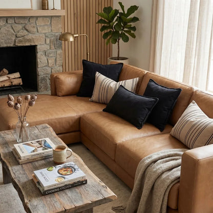 Cozy living room with brown sectional sofa, coffee table, and decorative elements.