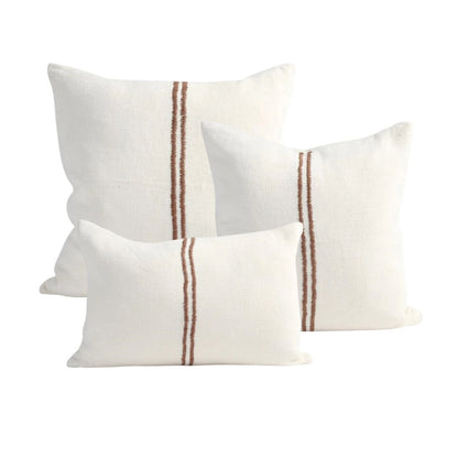 Three white pillows with brown stripes on a white background