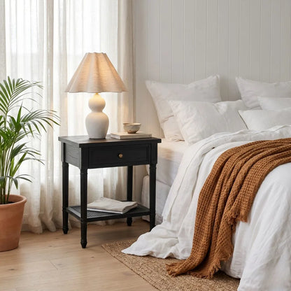 Cozy bedroom with a bed, nightstand, and lamp.