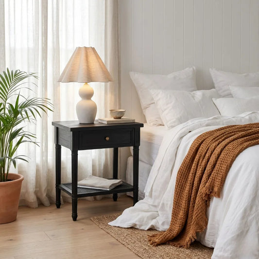 Cozy bedroom with a bed, nightstand, and lamp.