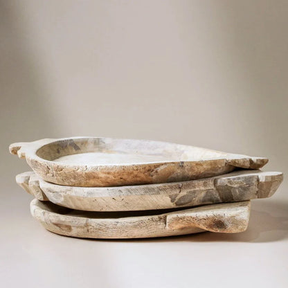 Set of three wooden trays stacked on a neutral background