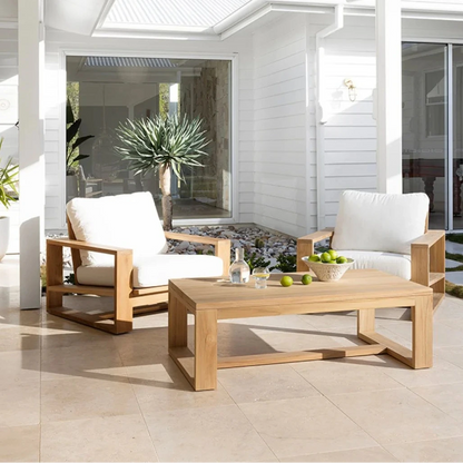 Outdoor patio set with wooden chairs and table on a tiled patio.