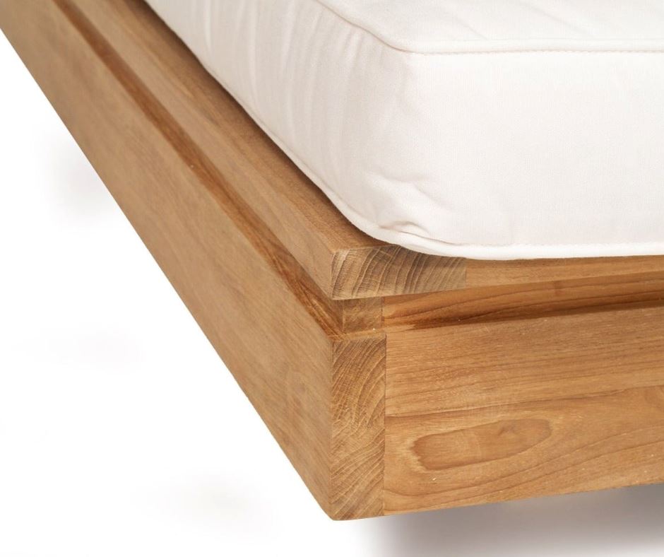 Teak outdoor sunlounge with white cushions on a white background 