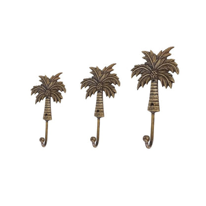 Three palm tree-shaped wall hooks on a white background
